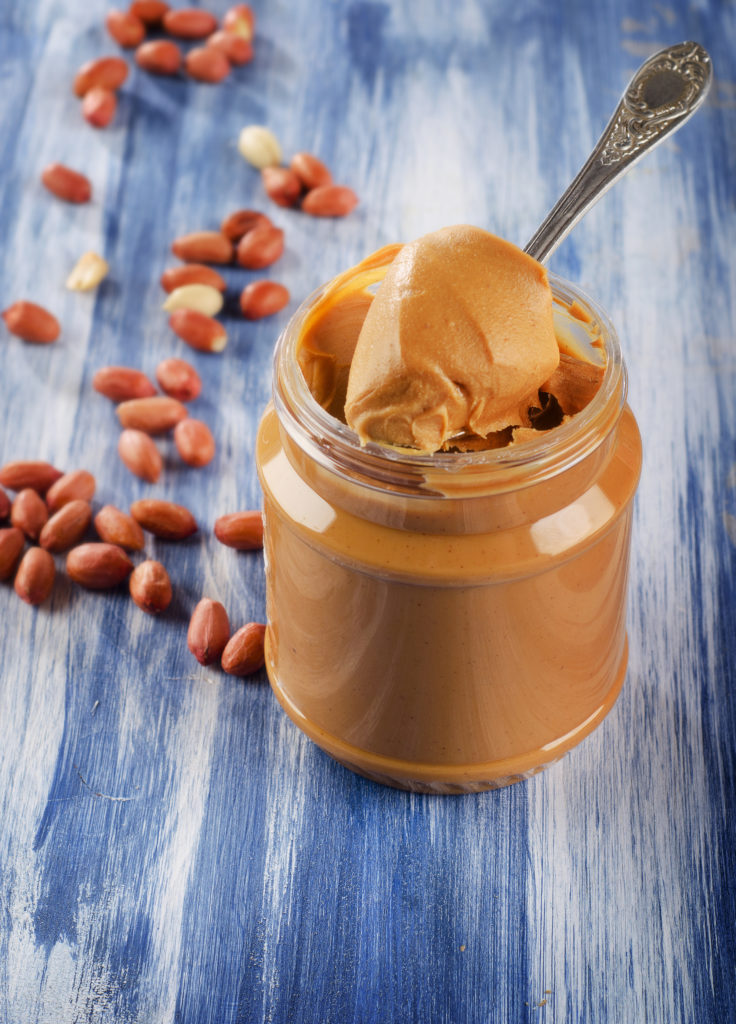 peanut butter in jar with peanuts