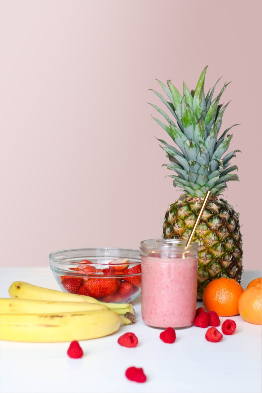 pink smoothie with pineapple banana and berries